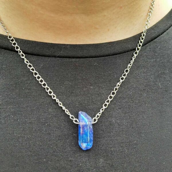 Handmade Blue Crystal Quartz Necklace. The Crystal Quartz point is suspended from a stainless steel chain.