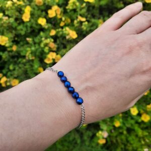 Handmade Blue Hematite Bracelet. Bracelet features a bar of Blue Hematite beads with stainless steel chain. Bracelet shown worn on wrist.