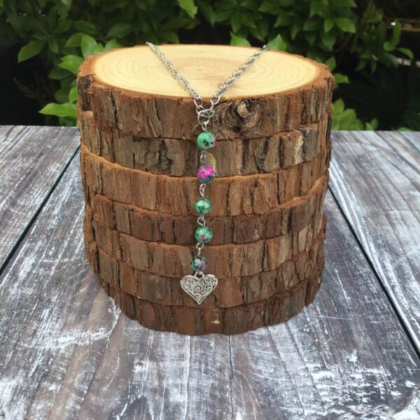 Handmade Ruby Zoisite beaded necklace with heart charm. Pendant suspended on a stainless steel curb chain.