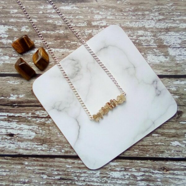 Golden Quartz chip bead bar necklace suspended on silver tone chain.