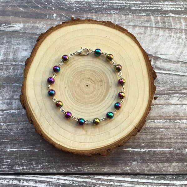 Beaded bracelet featuring multicoloured metallic Rainbow Hematite gemstones.