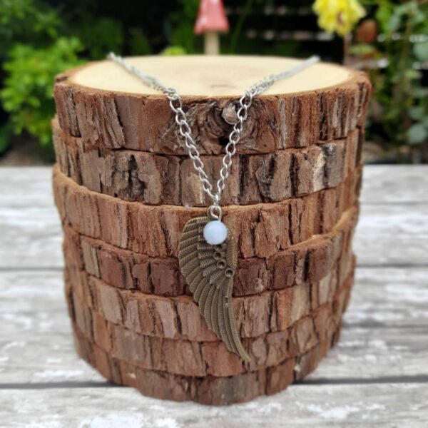 Handmade Angelite Angel Wing Necklace. Necklace features antique bronze finish angel wing and Angelite crystal bead.