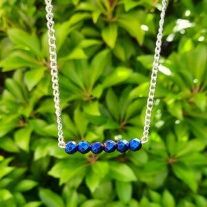 Handmade Blue Hematite Necklace. Features a row of faceted beads suspended from a stainless steel chain.