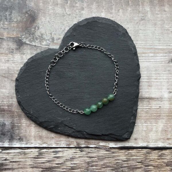 Handmade Green Aventurine Bracelet. Bracelet features a row of round Green Aventurine Beads on stainless steel wire which is suspended from stainless steel chain.