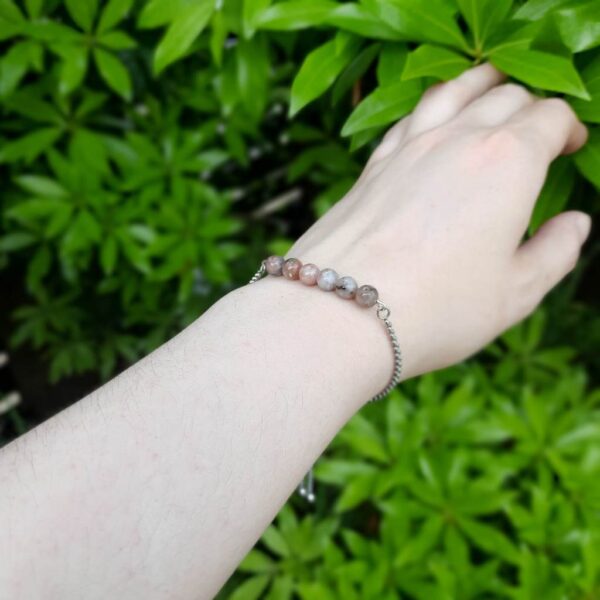Pink Lepidolite crystal bead stainless steel slider bracelet. Bracelet shown worn on wrist.