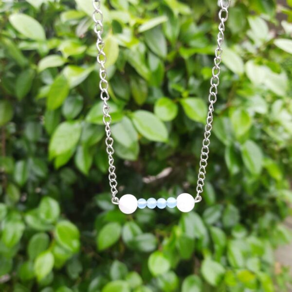 Handmade Rose Quartz and Cyan Malaysian Jade Necklace. Features a row of round beads on a stainless steel wire bar suspended on stainless steel chain.