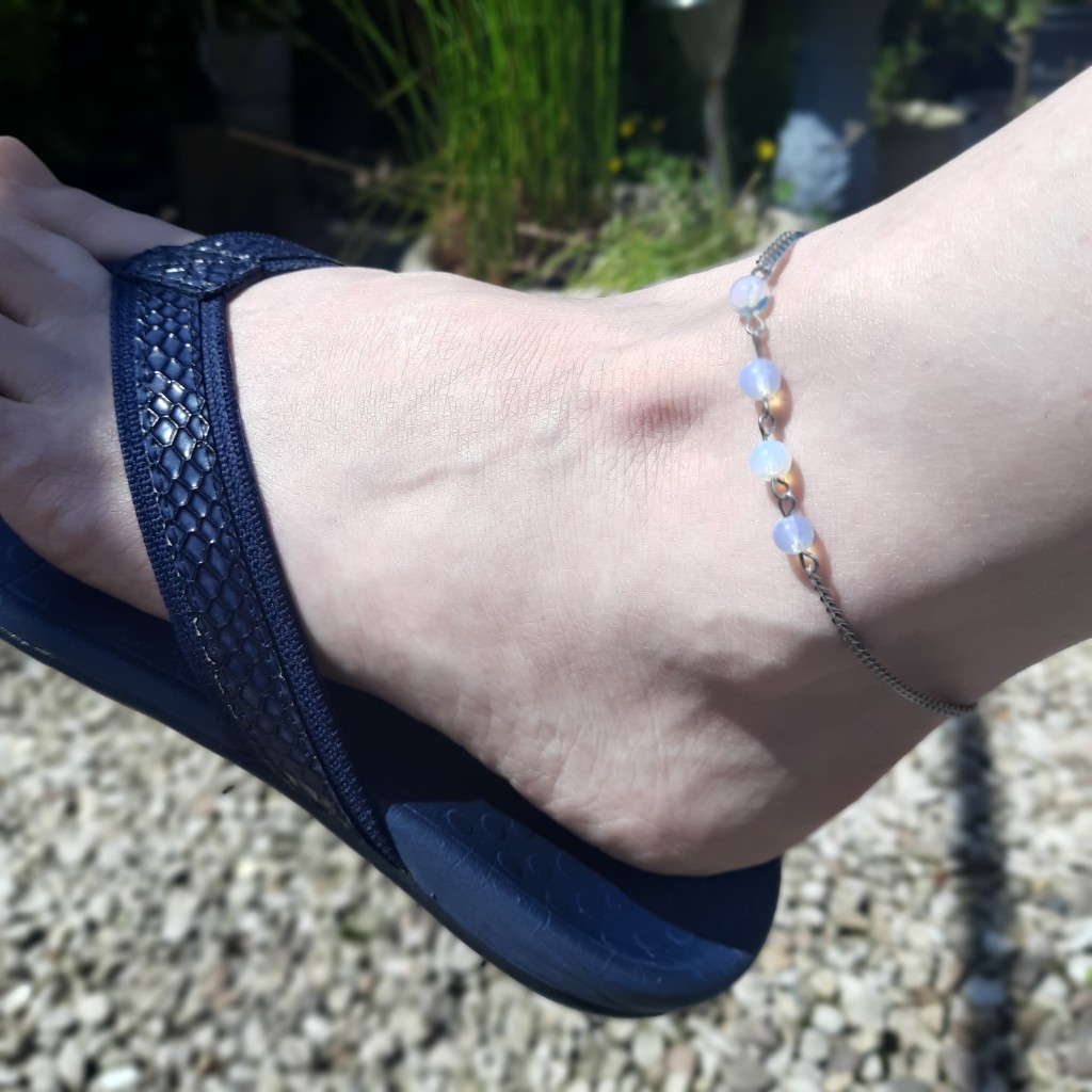 Handmade Opalite Anklet. Anklet features a row of round Opalite beads suspended on stainless steel chain.