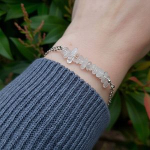 Handmade Crystal Quartz Bracelet. Bracelet features a row of Crystal Quartz chip beads on stainless steel wire suspended from stainless steel chain. Bracelet shown worn on wrist.