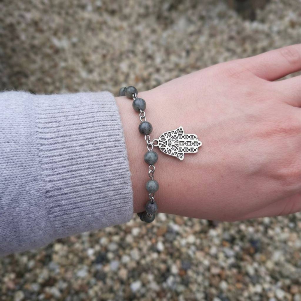 Handmade beaded bracelet featuring round Labradorite gemstones paired with an antique silver hamsa charm.
